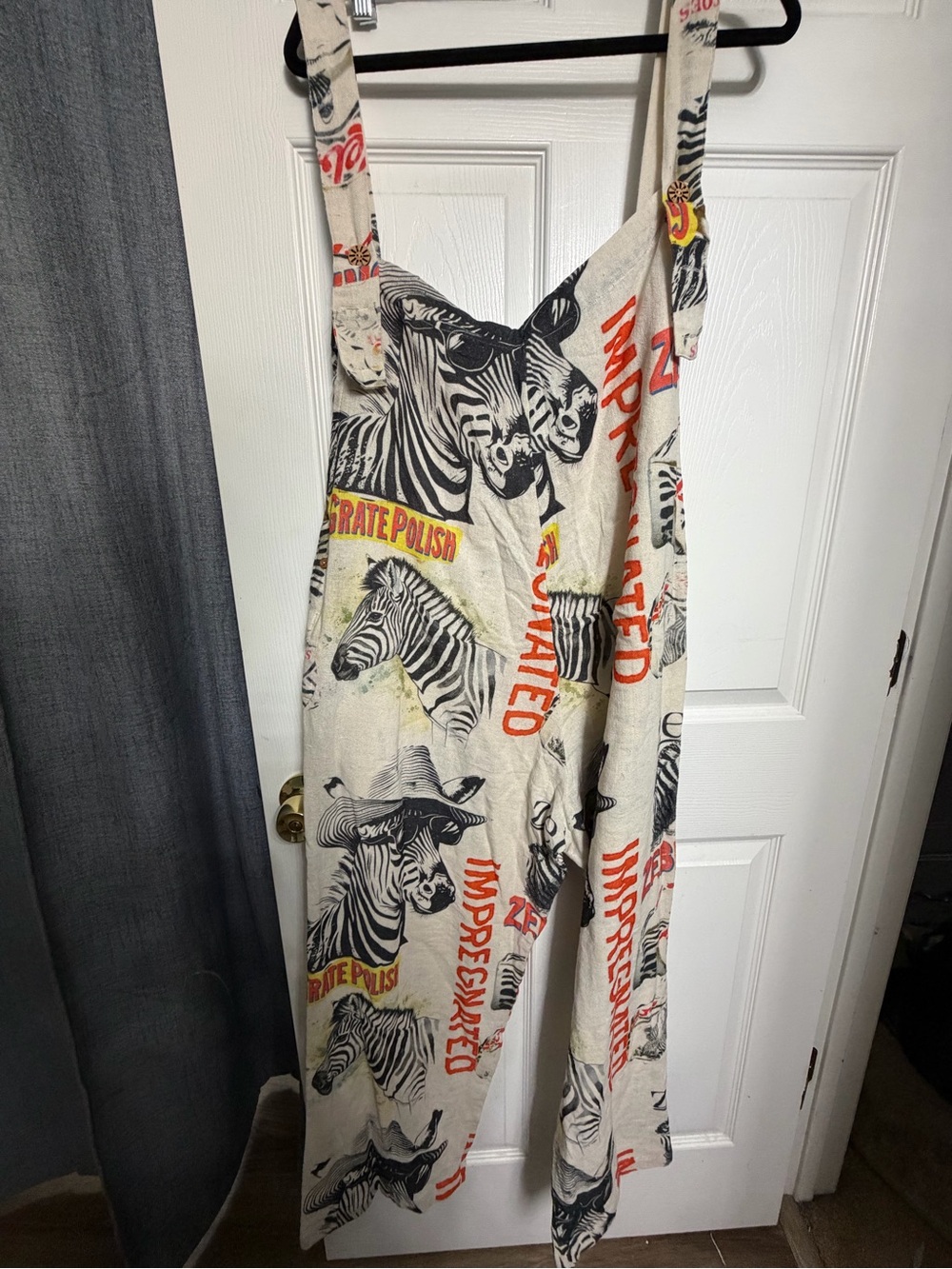 Karma Cream Zebra-Print Wide-Leg Jumpsuit with Red Graphic Text